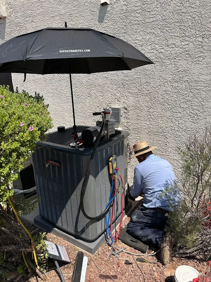 HVAC technician performing outdoor AC maintenance in New Baltimore
